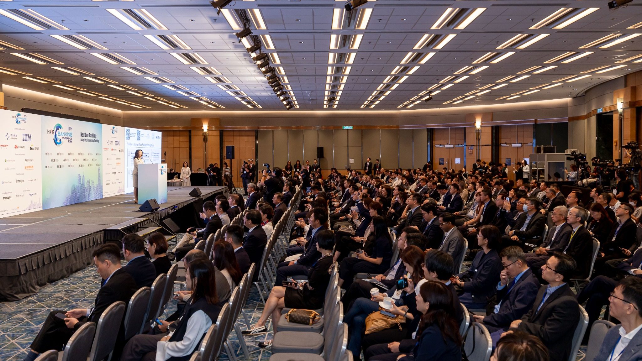 Wide conference audience shot showing strong attendance and event scale
